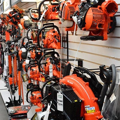 Husqvarna chainsaws on display in a store.