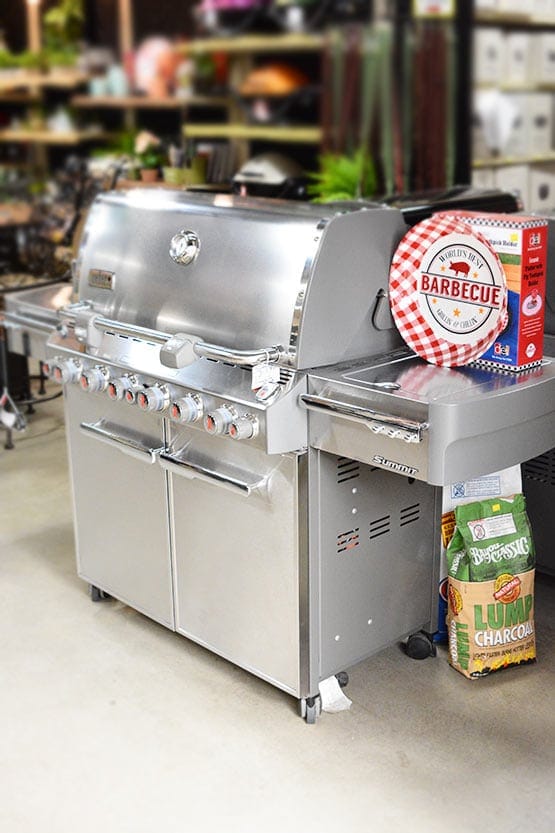 A stainless steel gas grill in a store.