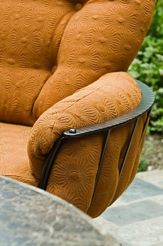 An orange upholstered chair with a metal frame.