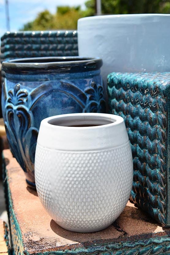 A group of blue and white ceramic pots on a table.