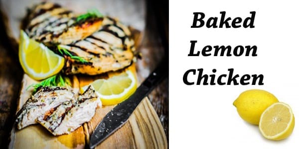 Baked lemon chicken with lemon slices on a cutting board.