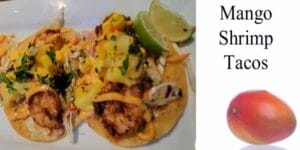 Mango shrimp tacos on a white plate with a garden center nearby.