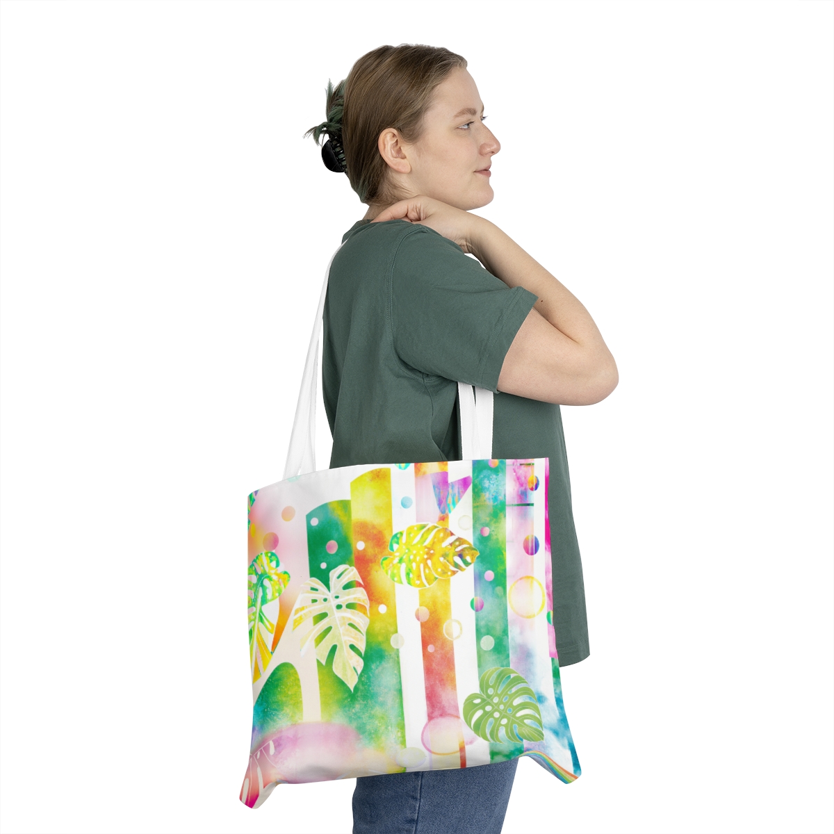 A woman holding the Pastel Monstera Shoulder Tote Bag by Green Thumb Nursery at a garden center near me.