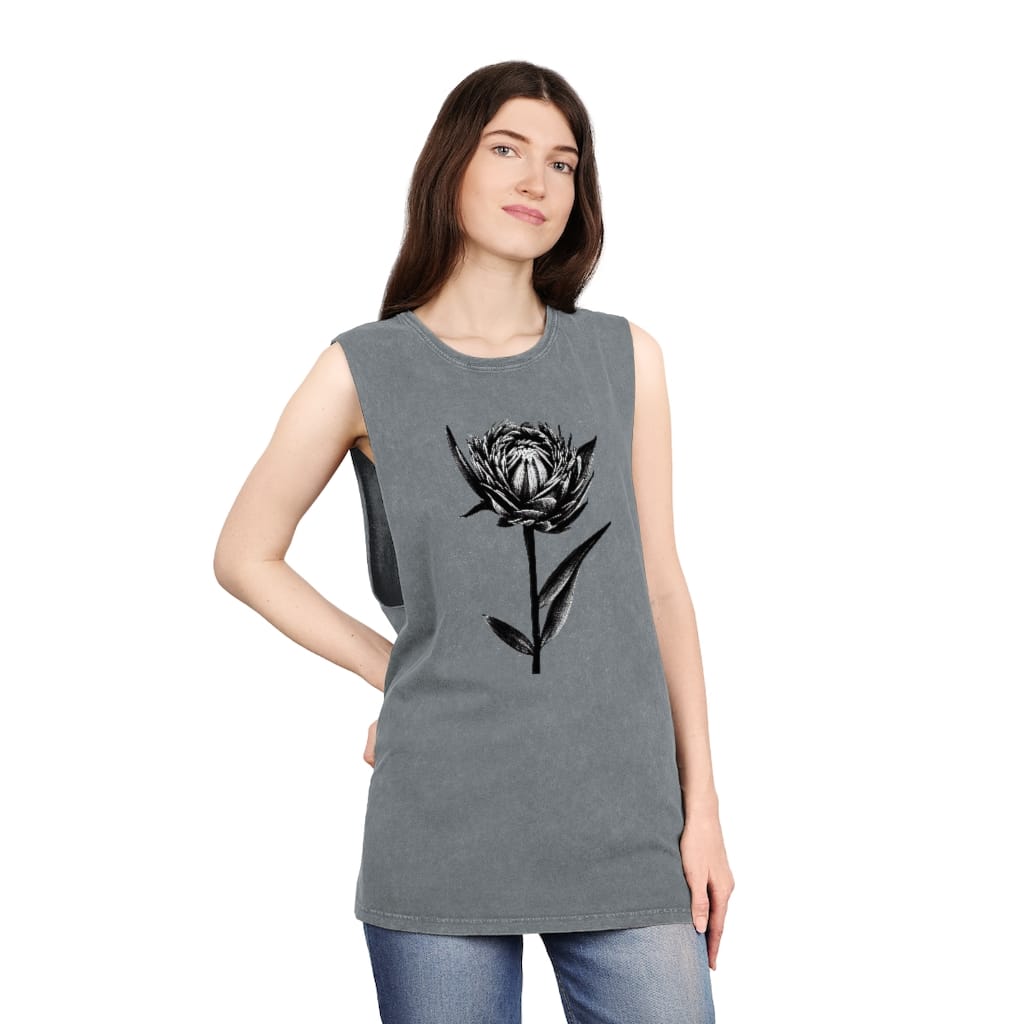 A woman wearing a B&W Pen Flower Art on Stonewash Tank Top by Green Thumb Nursery with a black flower near a nursery.