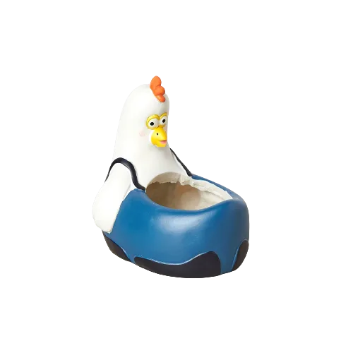 A toy chicken sitting in a blue bowl at the best garden center near me.