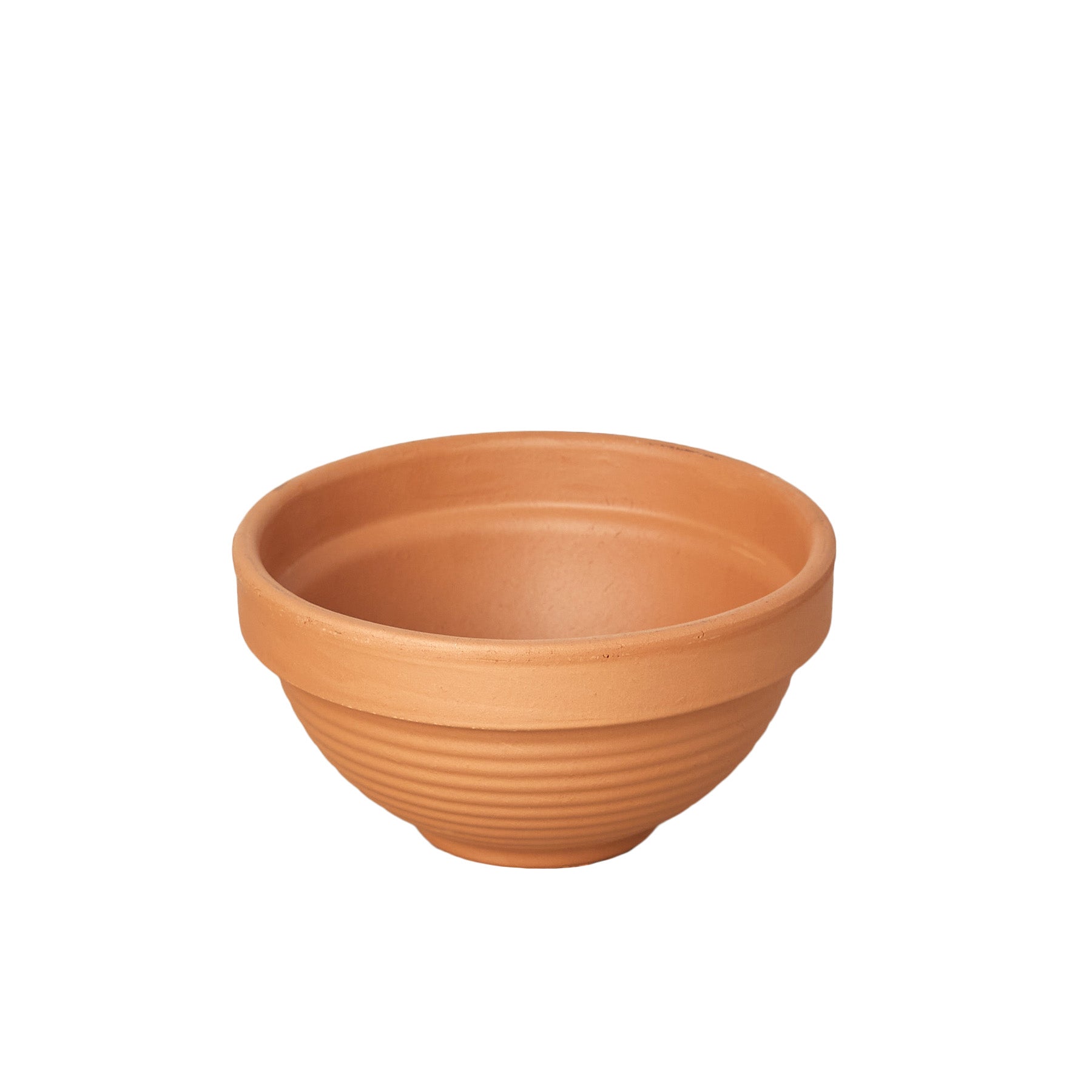 A small clay bowl amidst a serene white background.