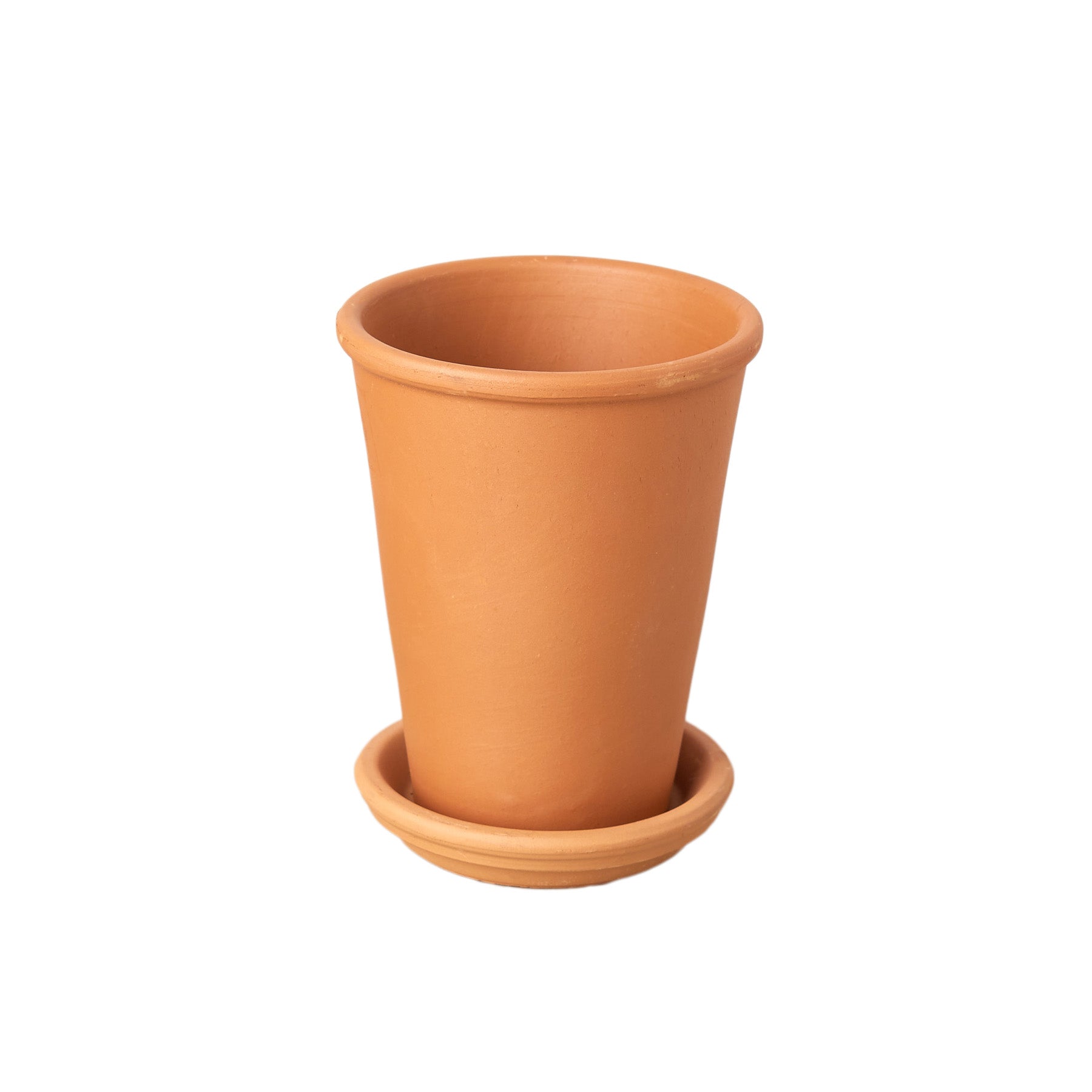 A small clay pot on a white background at one of the best plant nurseries near me.