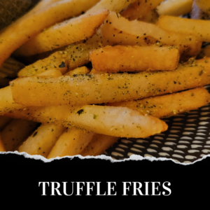 A close-up of seasoned truffle fries in a basket, with flecks of herbs visible on the fries.