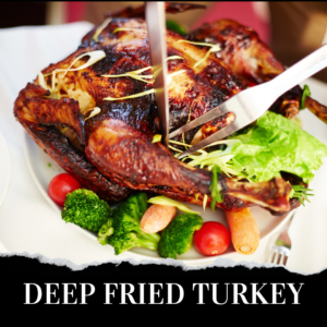 A deep fried turkey on a plate with vegetables.