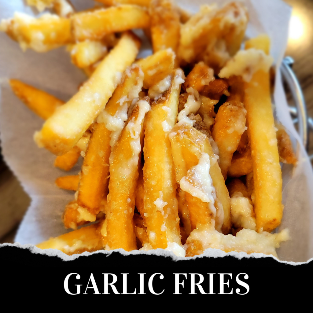 Garlic fries in a basket on a table.