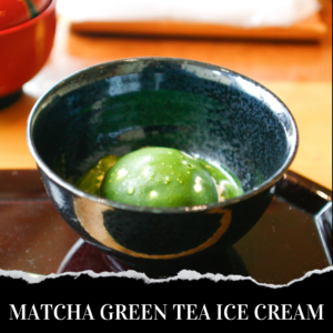 A scoop of matcha green tea ice cream in a black bowl.