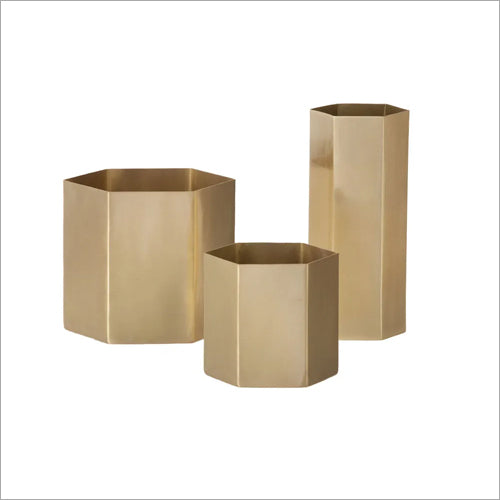 Three gold-colored, geometric metal planters in hexagonal shapes, with varying heights, on a white background.