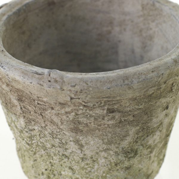 A weathered, moss-covered stone pot with a rough texture and rounded shape, viewed from above against a white background.