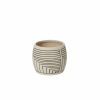 Ceramic planter with geometric black lines on a beige background.